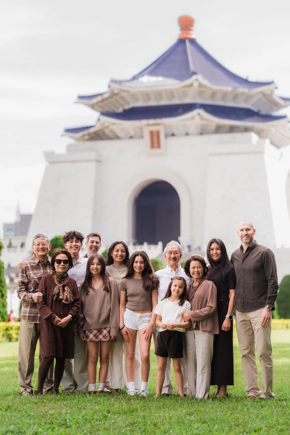 A family group photo taken in front of the Chiang Kai-shek Memorial Hall in Taipei, Taiwan.