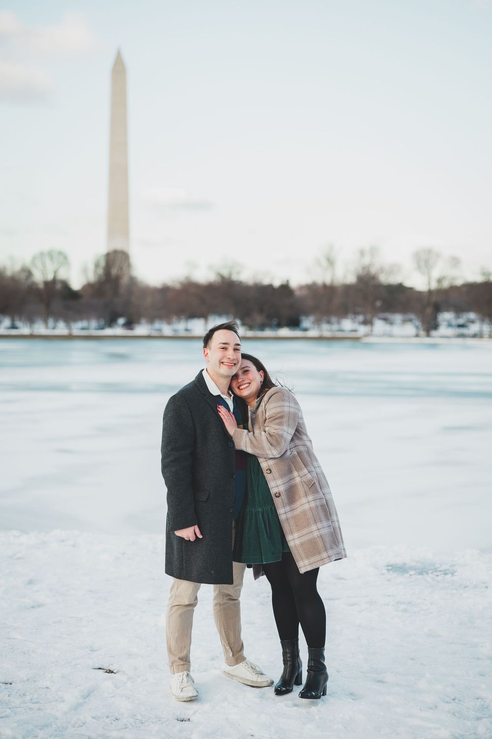A snowy winter scene at the National Mall with the Washington Monument in the background.