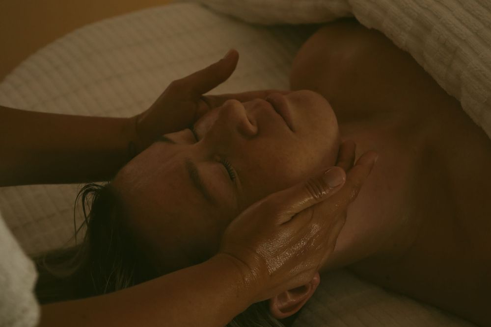 Close-up shots of various massage therapy techniques being performed on clients in a relaxing spa environment.