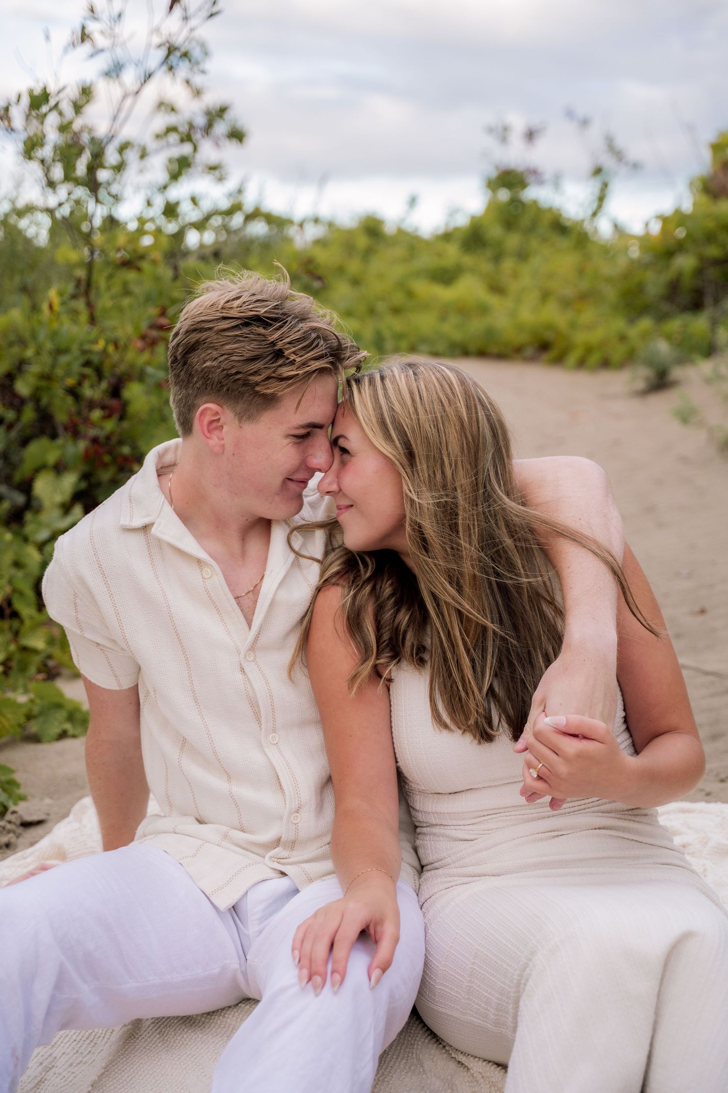 A romantic black and white photo series showing a couple embracing and sharing tender moments together.