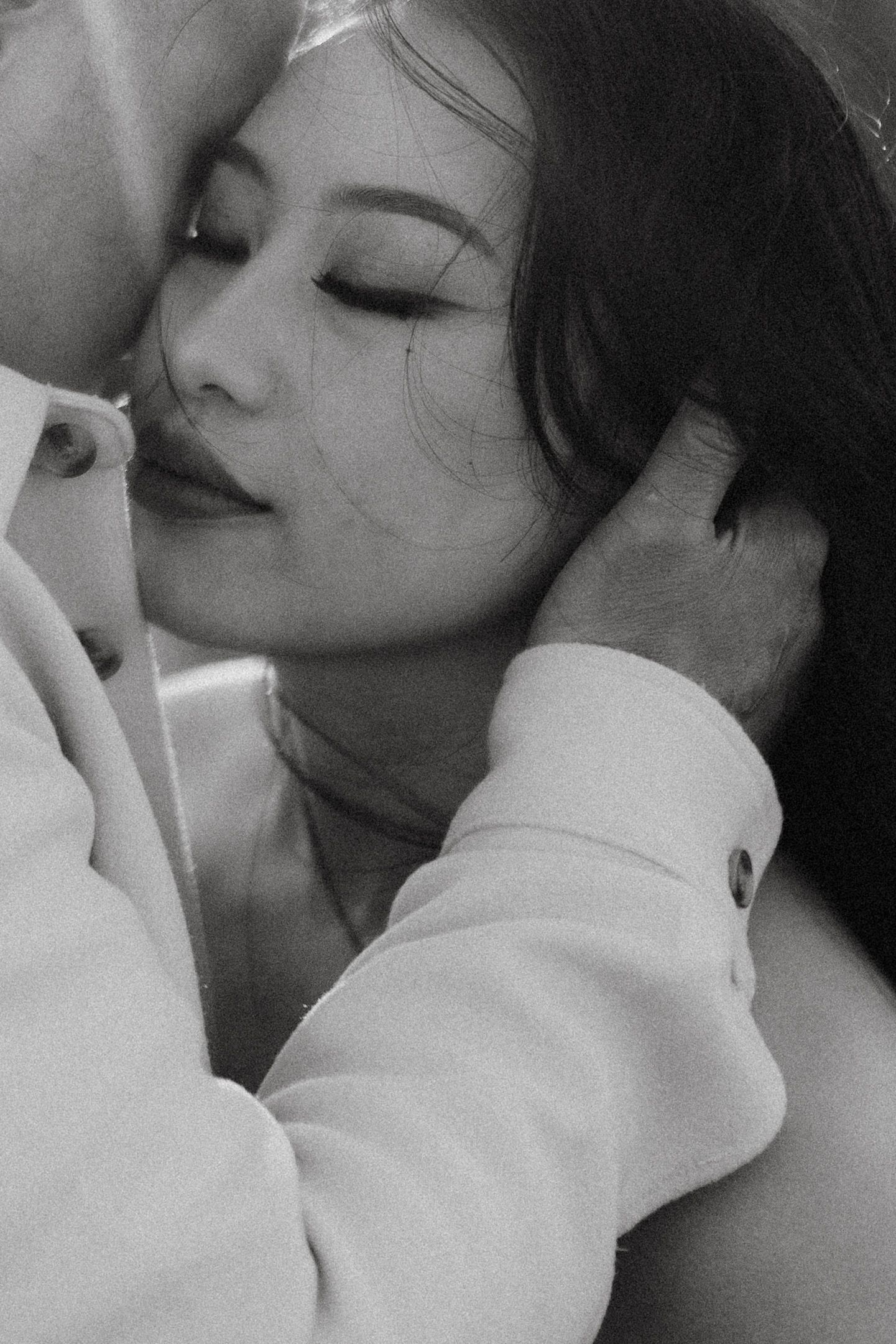 A series of black and white close-up photos showing intimate moments of affection and tenderness.
