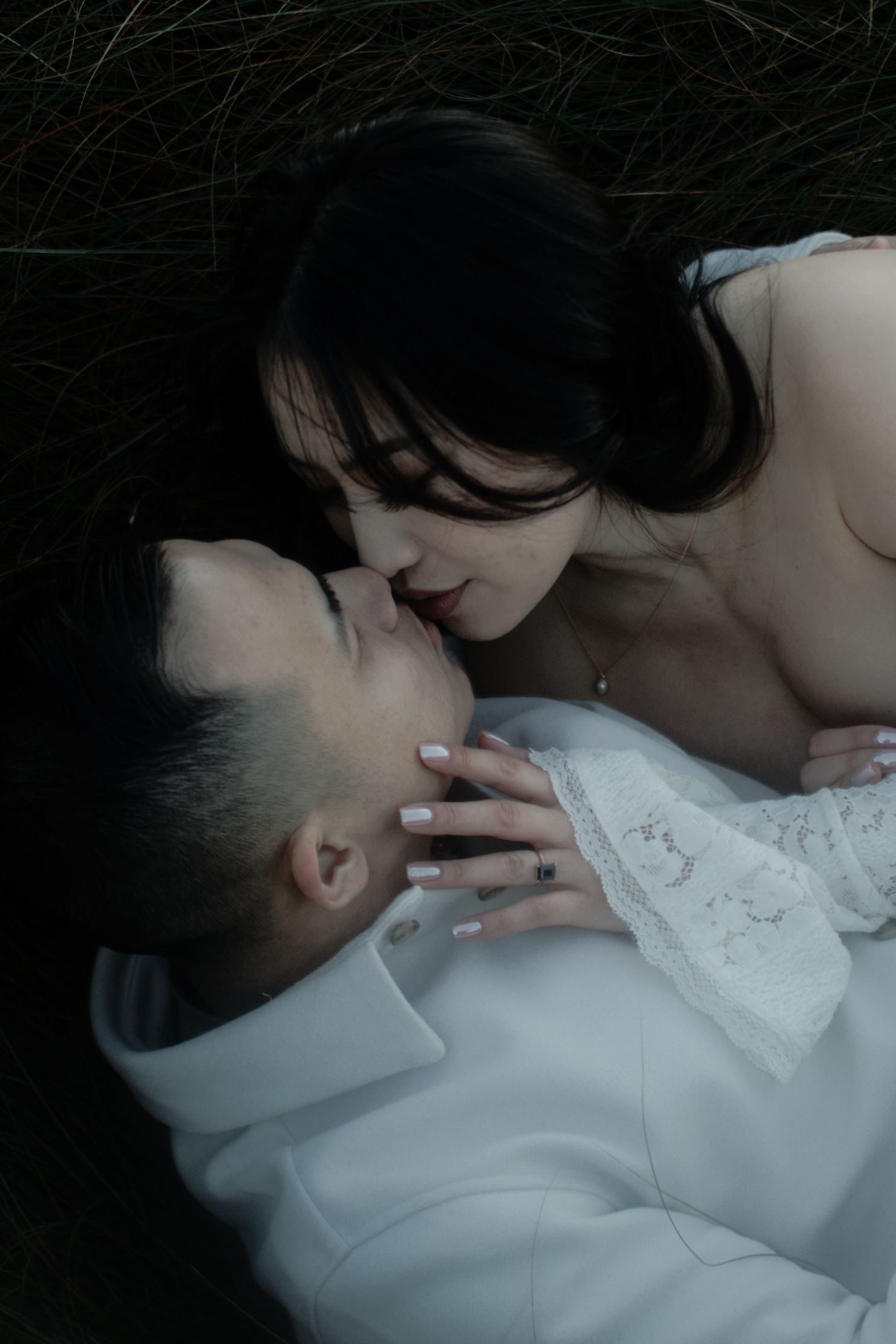 A series of intimate black and white photographs showing two people in close embrace wearing white clothing.
