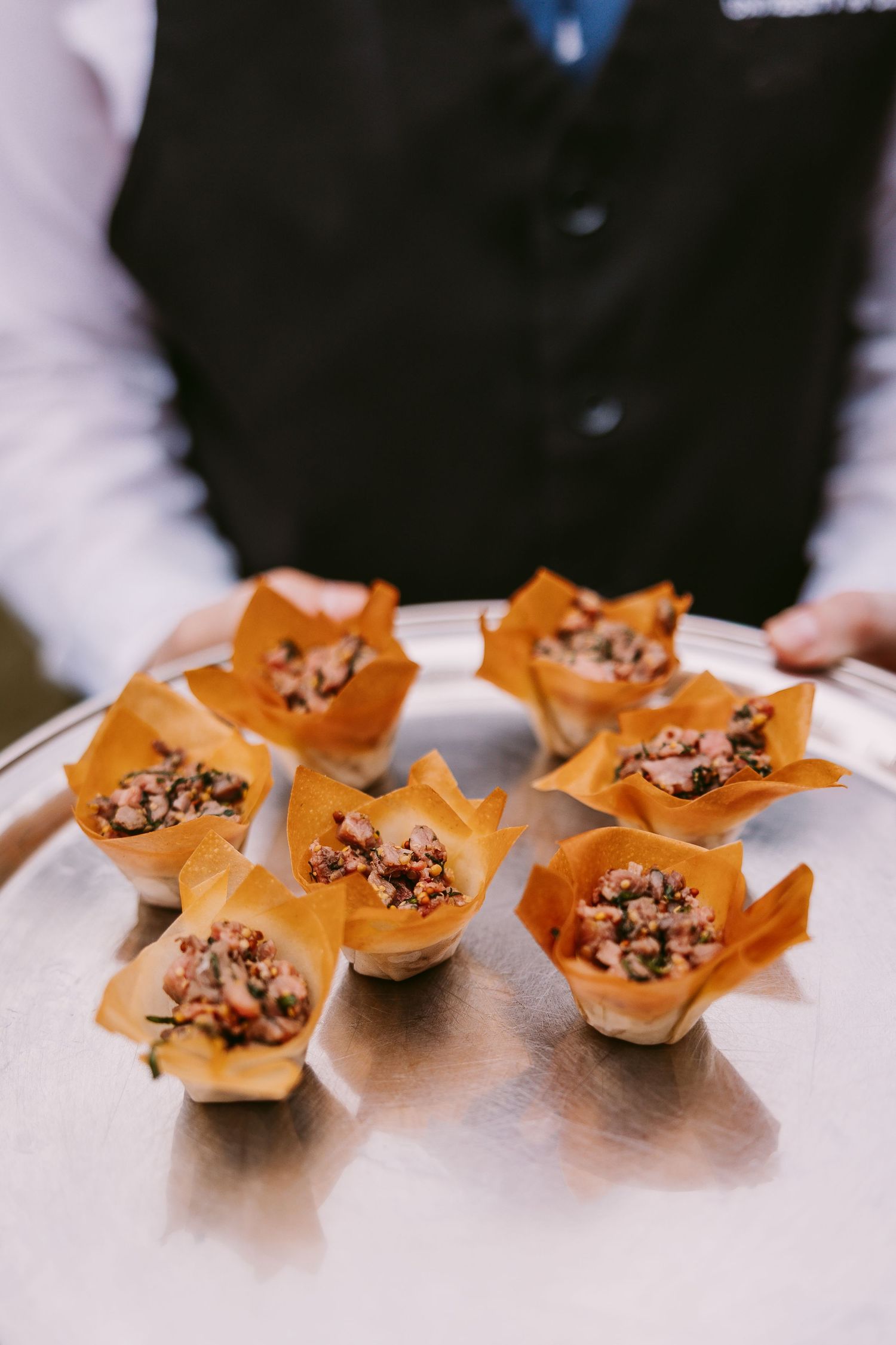 Three golden pastries with chocolate and nut filling arranged on a white surface.