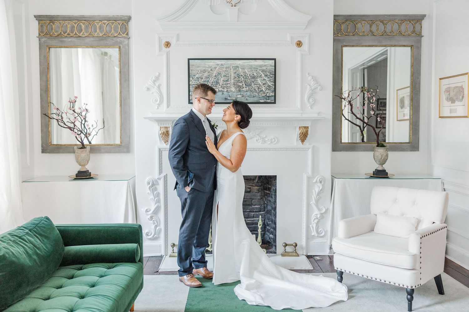 Elegant wedding venue interior with white walls, ornate moldings, and multiple framed artworks displayed in a row.