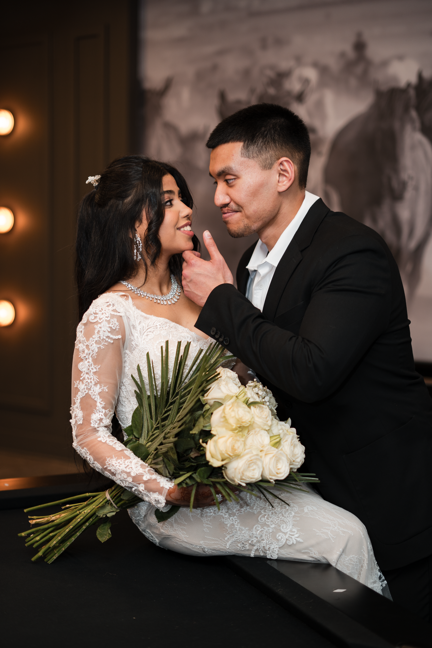 Asian bride and groom sharing romantic moment with white peony bouquet at elegant wedding.