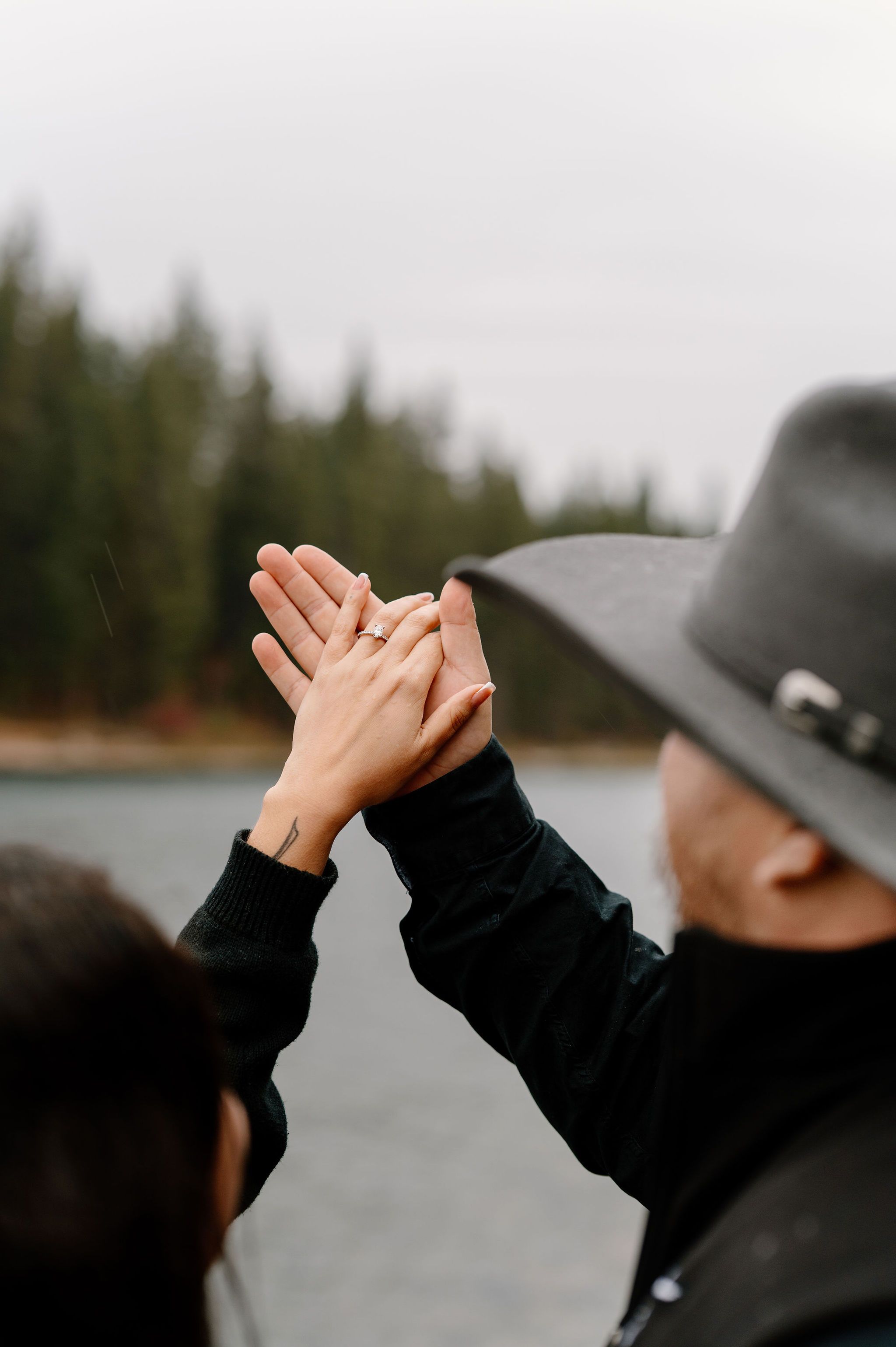 Cinematic lake engagement photos in the rain