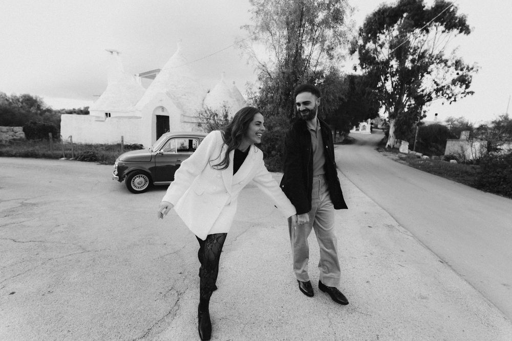 Black and white photo series showing couple walking and holding hands on a sidewalk.