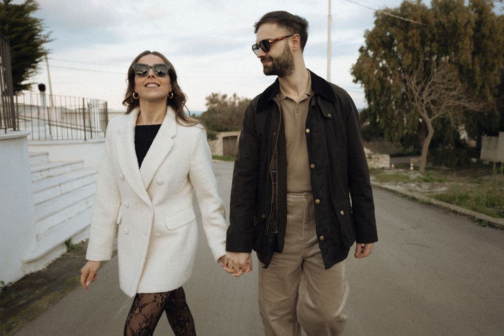 Candid shots of a couple walking together on a street in casual outfits.