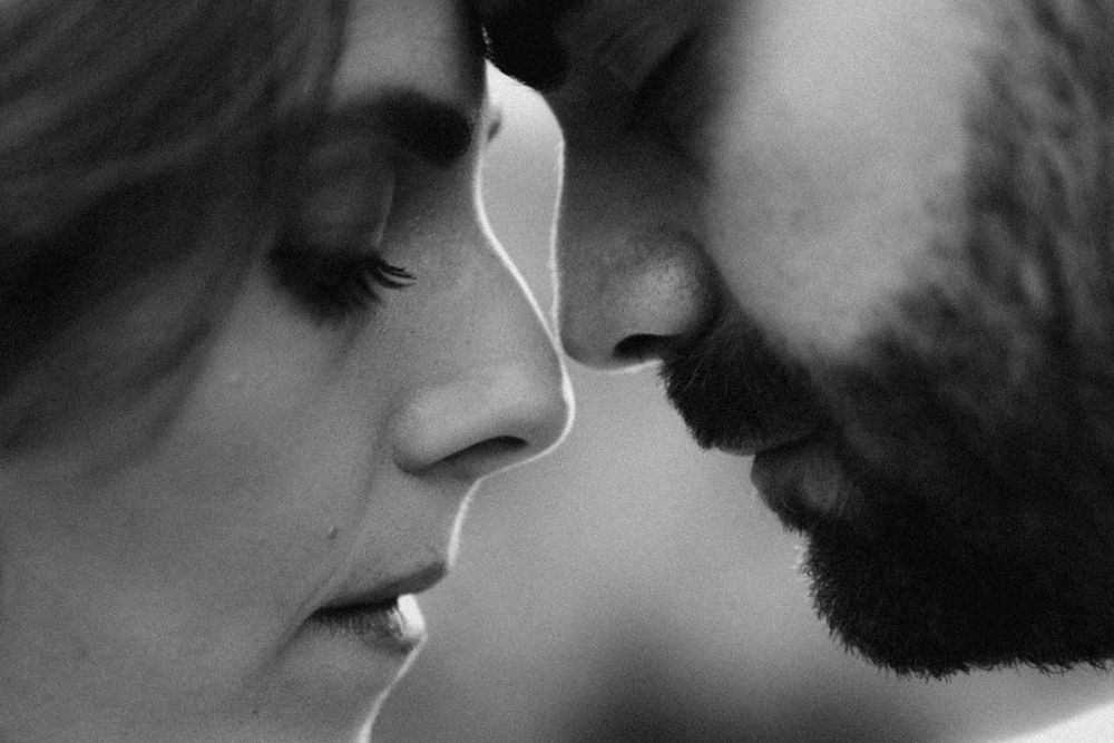 A series of black and white close-up profile shots showing an intimate moment between two people.