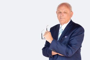 Corporate headshot of a realtor, arms crossed with confident smile