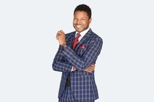 Corporate headshot of a realtor, arms crossed with confident smile