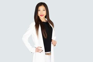 Natural light headshot of female real estate professional smiling warmly