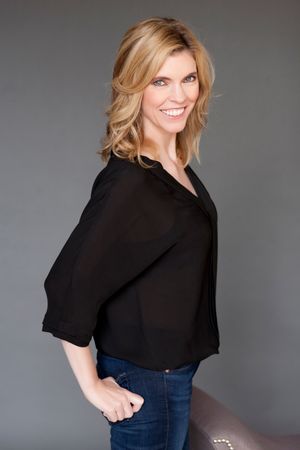 Individual realtor portrait: smiling professional real estate agent in studio lighting