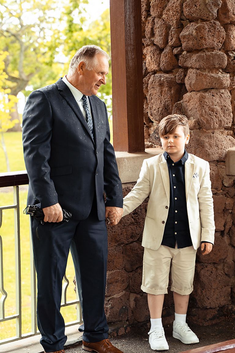 A series of four photos showing a person in a dark suit and a small child in light colored clothing standing together.