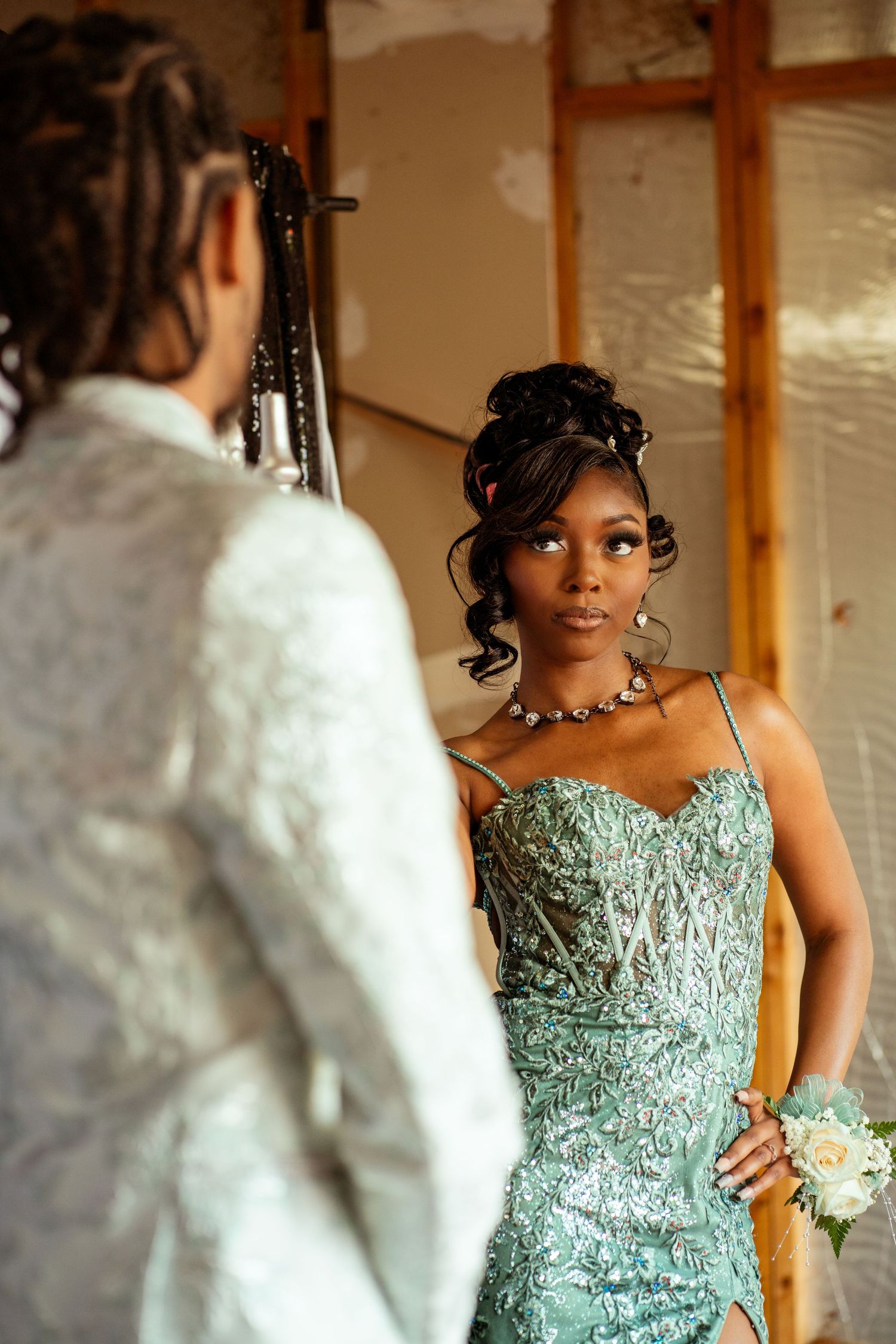 Elegant mint green formal dress with sparkly details captured in intimate moment.