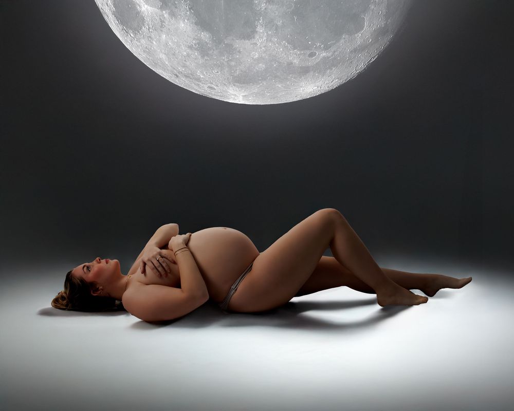 Artistic photo series shows a nude figure reclining against dark backdrop with full moon phases in sequence.