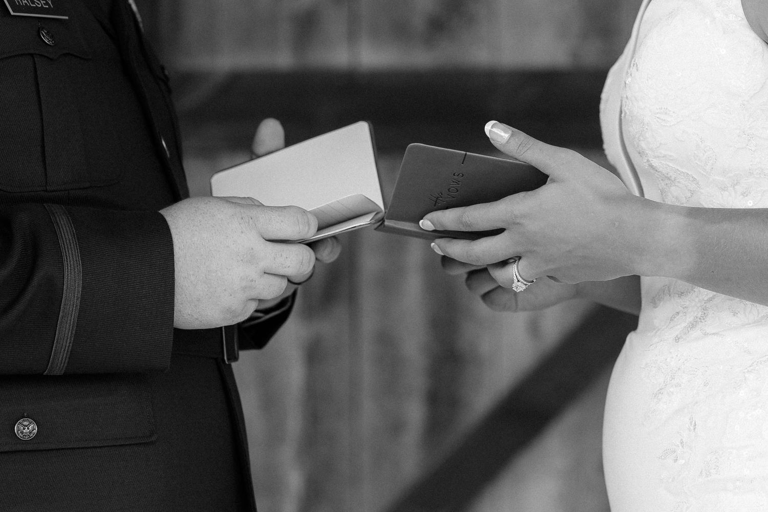 Intimate black and white portrait of newlyweds with delicate veil detail.