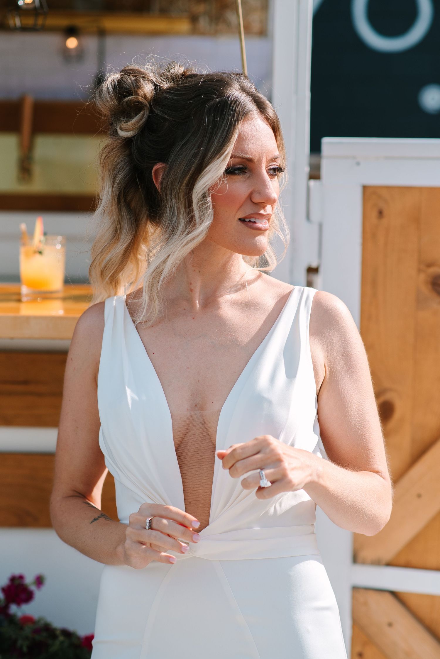 Elegant white plunging neckline wedding dress shown in natural lighting.