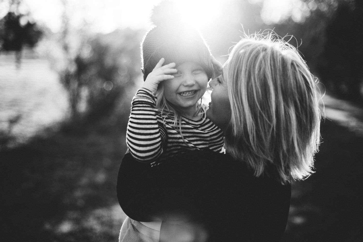 Candid mother and child moment, family photography in Lincoln, CA. Emotional embrace captured at golden hour.