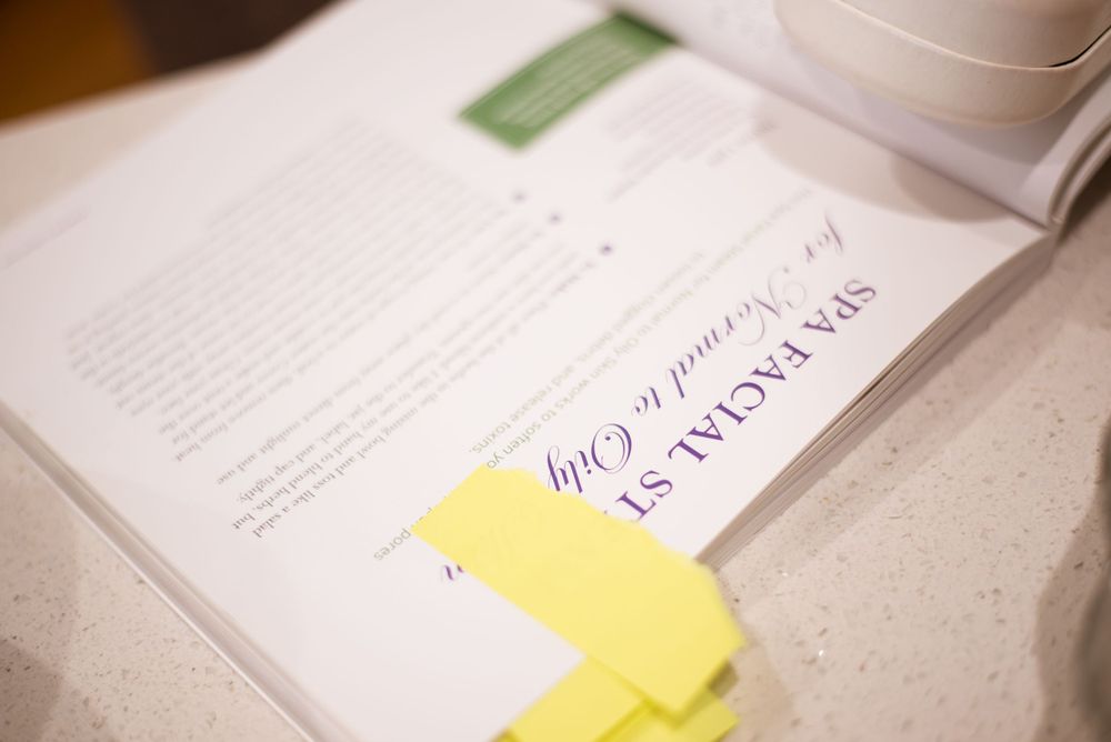 An open notebook with yellow sticky notes and handwritten text on white pages.