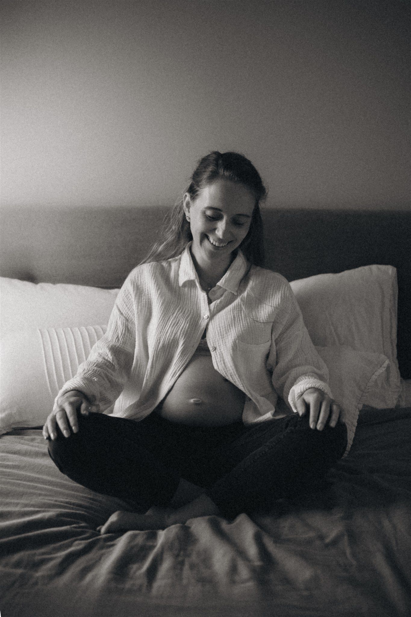 Pregnant lady sitting on the bed