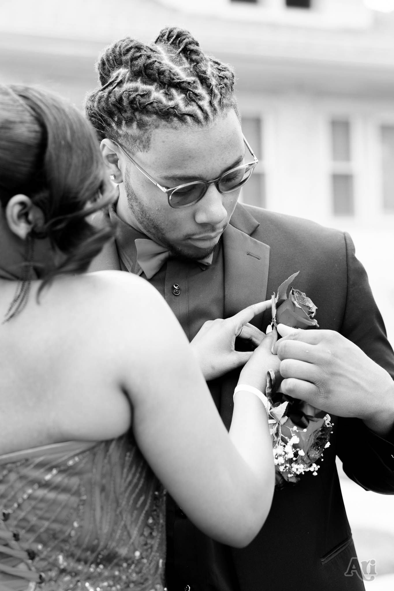 Black and white prom corsage moment captured in formal attire.