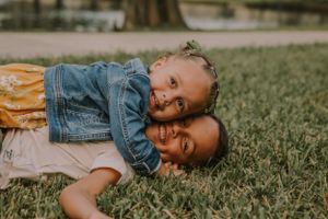 Playful family interactions captured in natural outdoor setting.