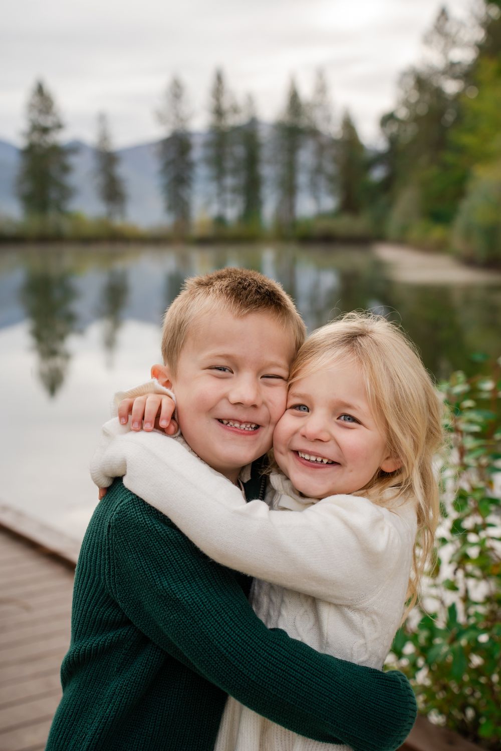 sibling portrait by the pond