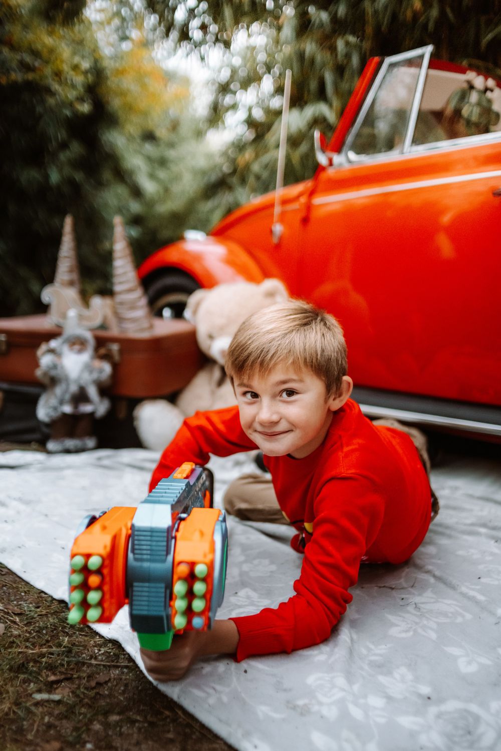 Mini-session photo de Noël 2024 avec une coccinelle VW rouge décorée pour les fêtes, créant une ambiance festive et chaleureuse.