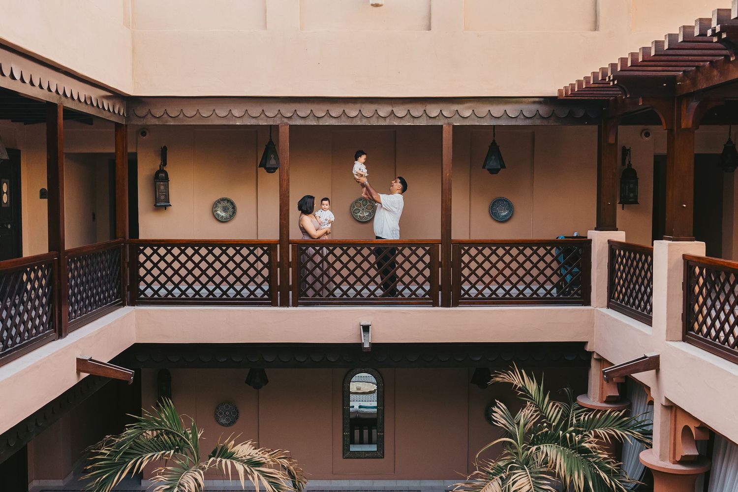 Family photography session at traditional Arabian hotel courtyard in Dubai
