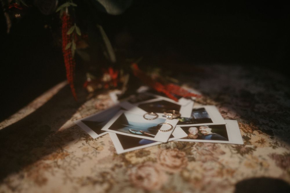 Vintage polaroid photographs scattered in dramatic lighting.