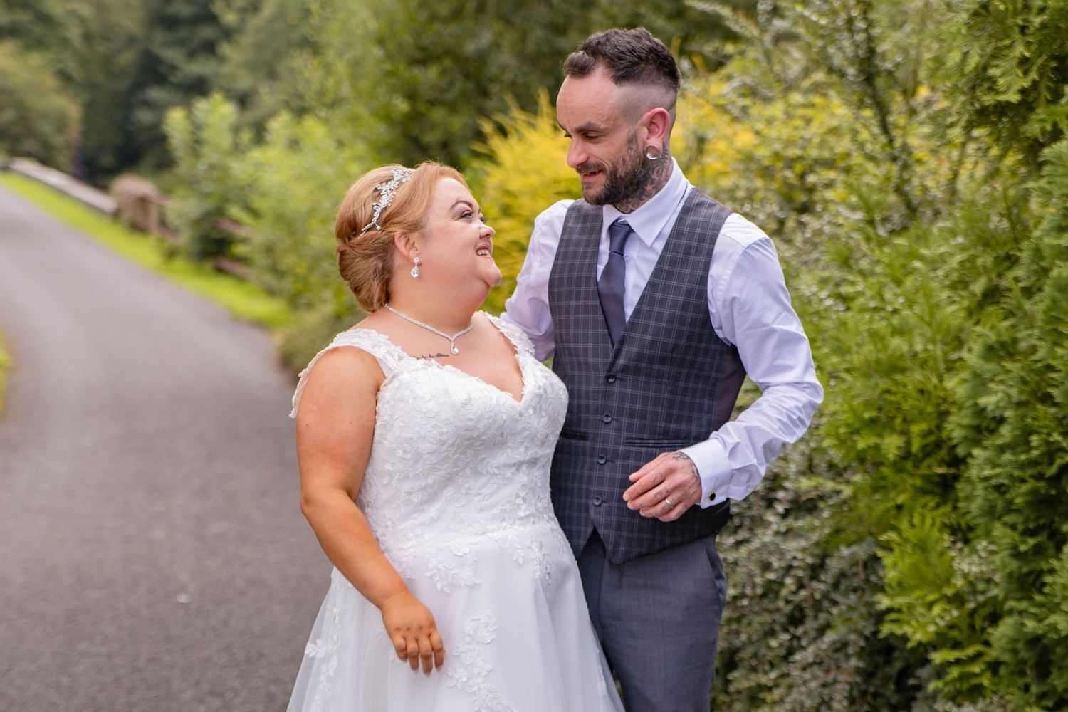 Outdoor wedding photography session showing romantic couple poses on a garden path.