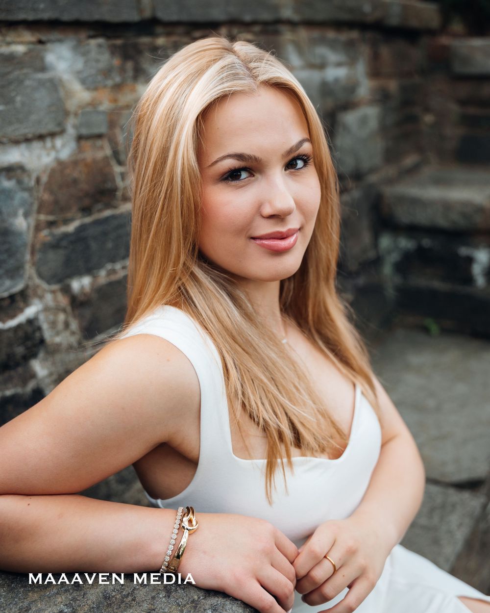 A photoshoot series against a stone wall background showing outdoor portrait poses and expressions.