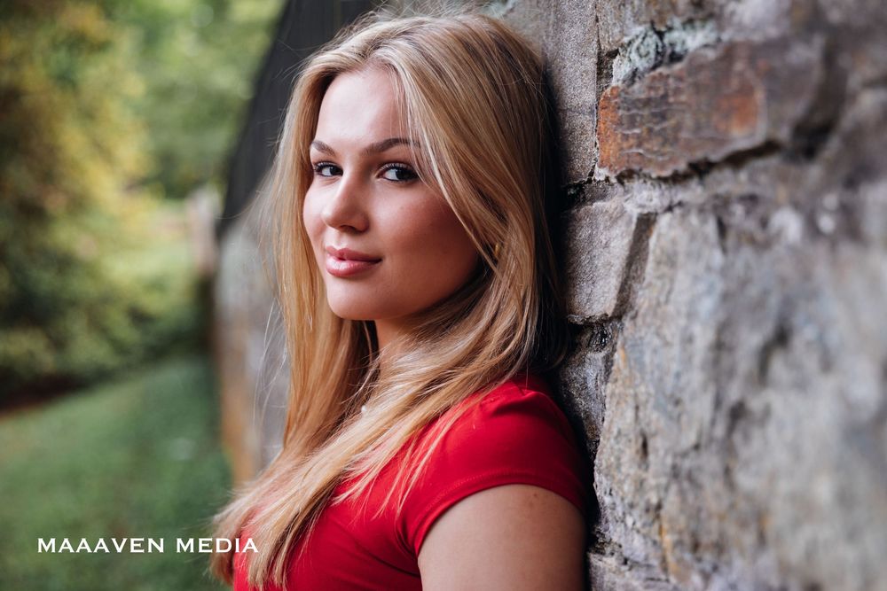 Portrait series captured against a rustic stone wall backdrop in natural lighting.