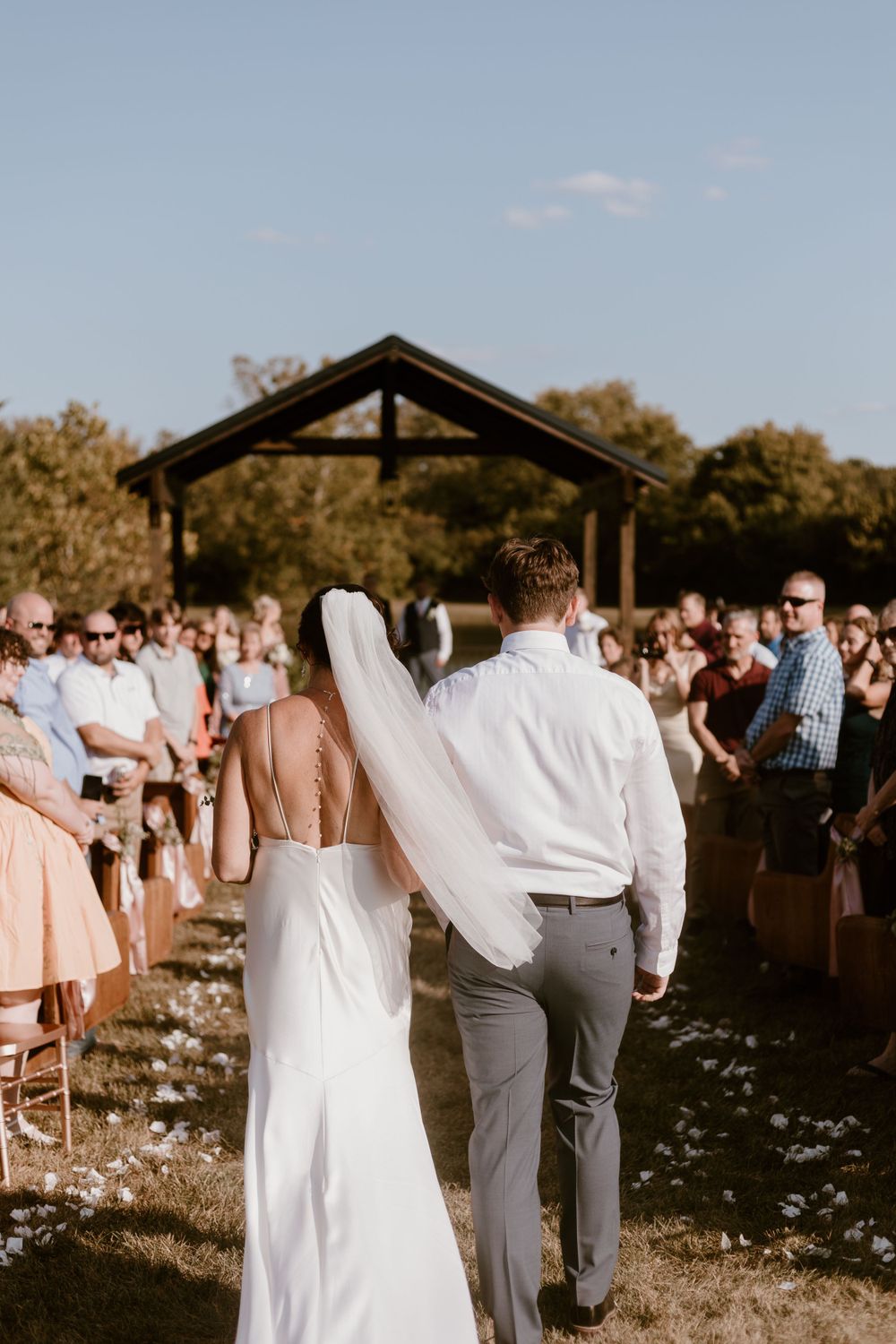 Son walking mom down aisle for summer backyard wedding in Ohio photography by Vicci Photo Dayton Ohio Photographer