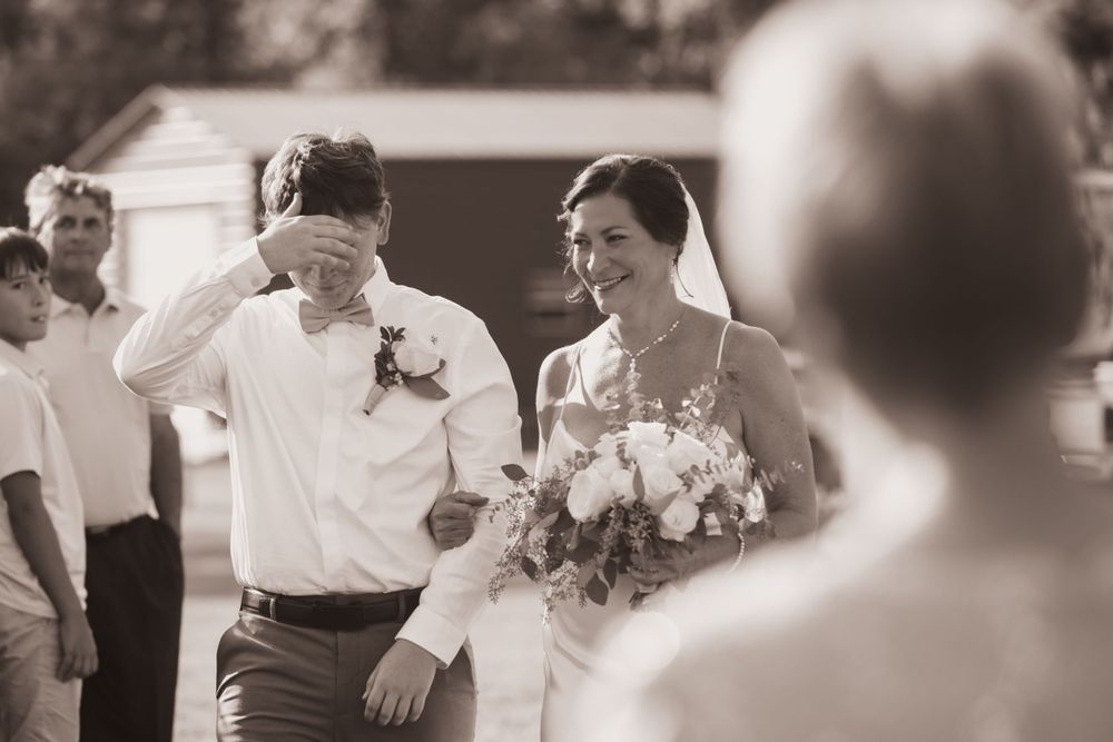 Son walking Bride down the aisle, black and white photo for summer backyard wedding in Ohio photography by Vicci Photo Dayton Ohio Photograp