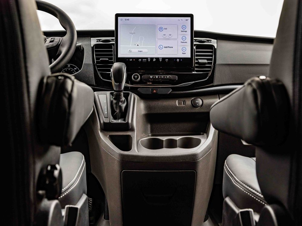 Modern vehicle dashboard with large touchscreen display and premium finishes.