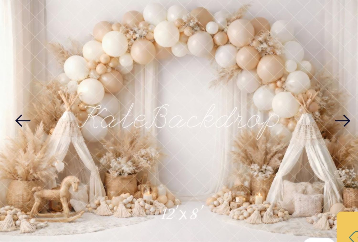 Boho-themed photo backdrop with balloon arch in neutral tones, pampas grass, teepees, and a toy horse.