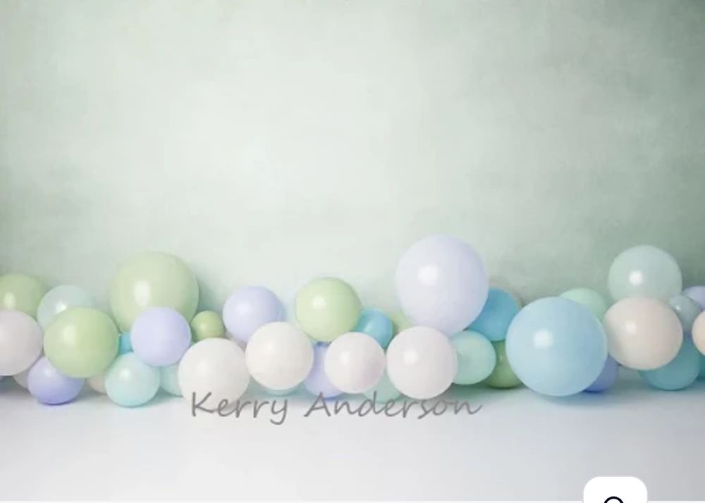 Soft pastel balloon garland backdrop in mint, blue and white colors.