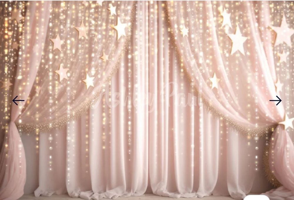 Dreamy pink backdrop with twinkling star lights and draped curtains for special events.