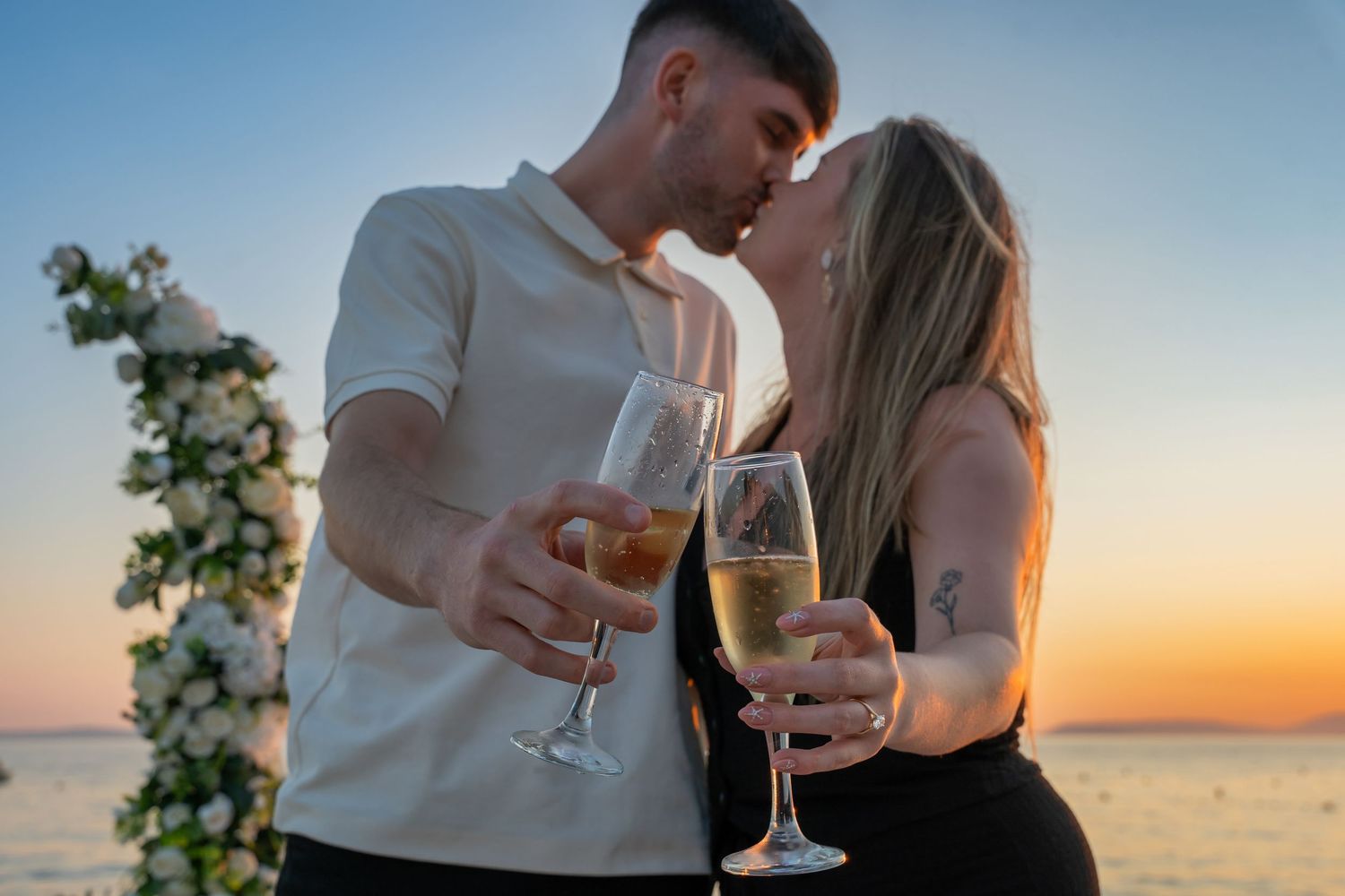 Proposal at the beach with sunset in Split Podstrana Croatia with flower arch