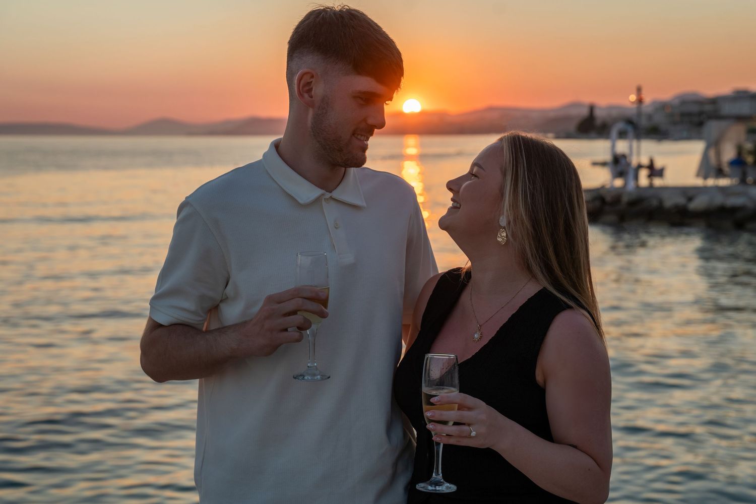 Proposal at the beach with sunset in Split Podstrana Croatia with flower arch
