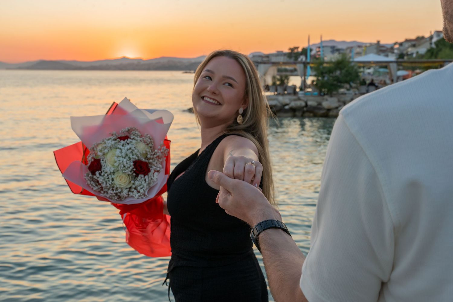 Proposal at the beach with sunset in Split Podstrana Croatia with flower arch