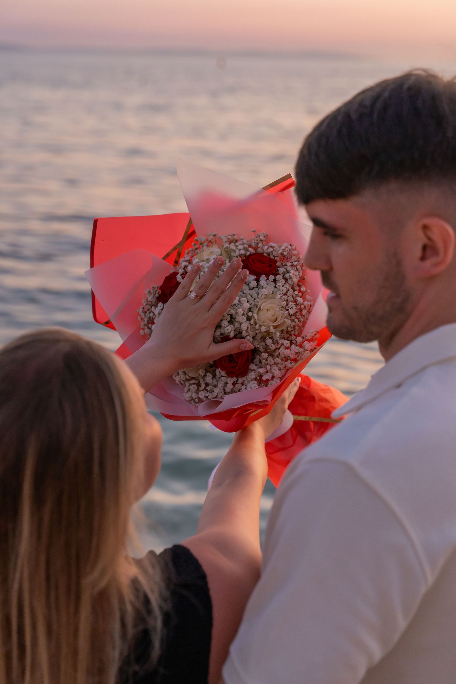 Proposal at the beach with sunset in Split Podstrana Croatia with flower arch