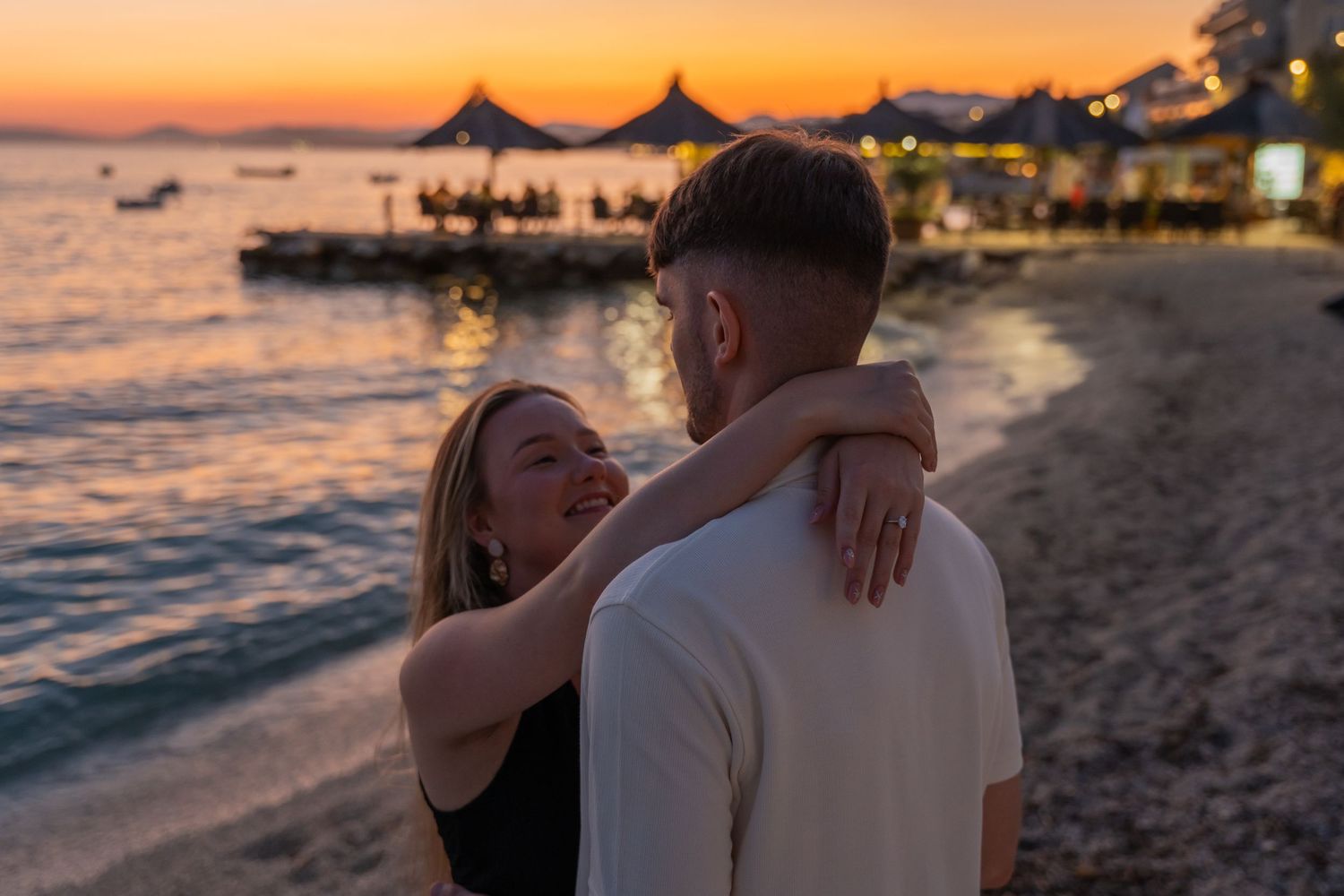 Proposal at the beach with sunset in Split Podstrana Croatia with flower arch