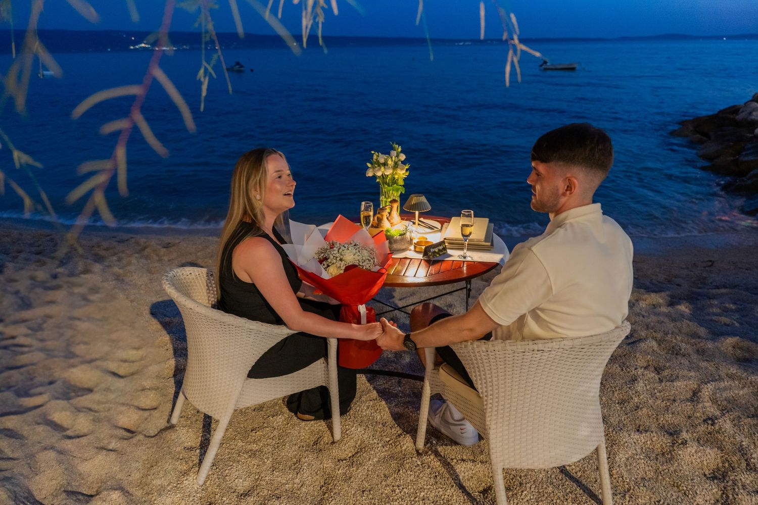 Proposal at the beach with sunset in Split Podstrana Croatia with flower arch