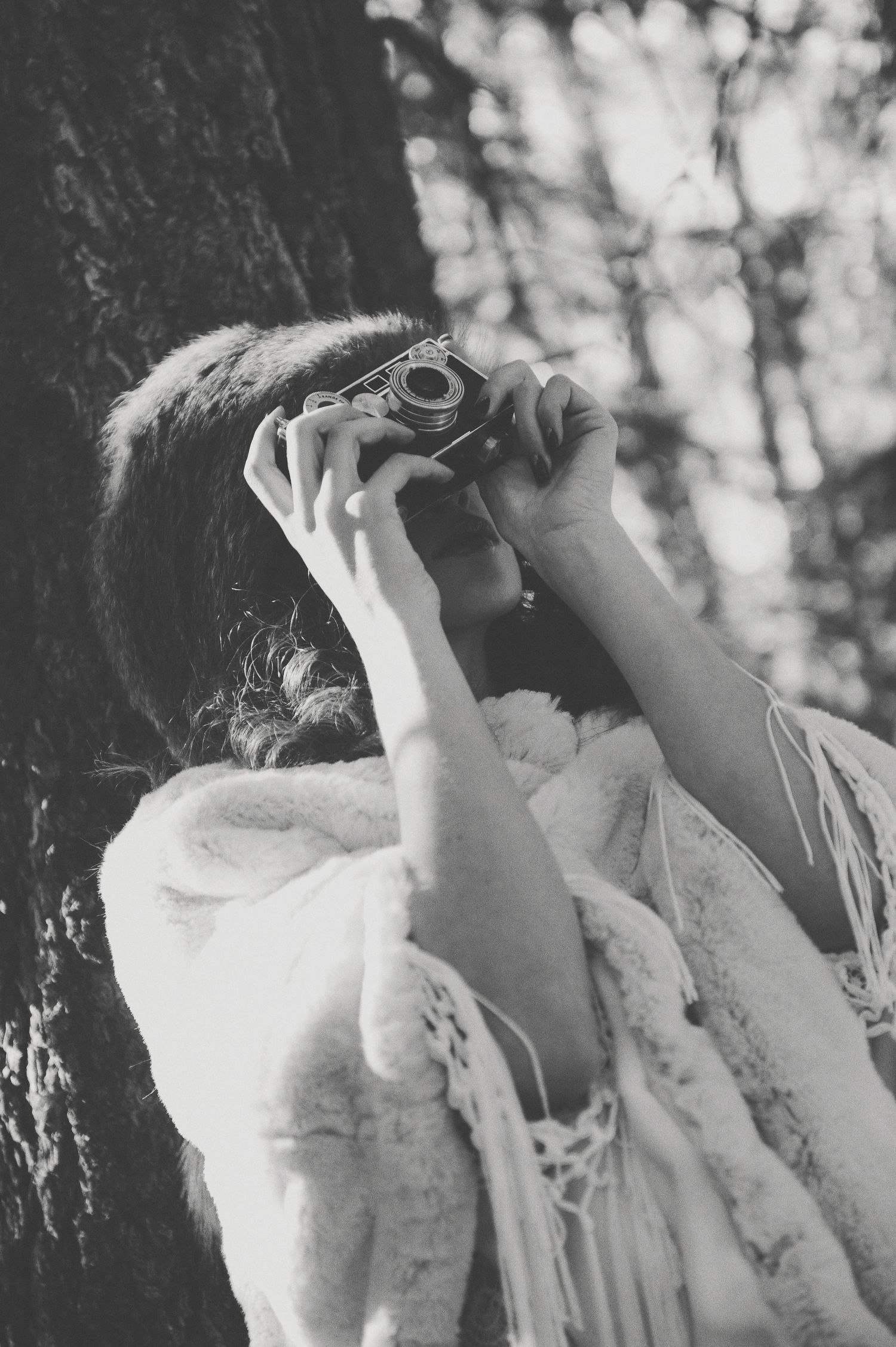 Black and white artistic photograph showing delicate lace details in soft focus.