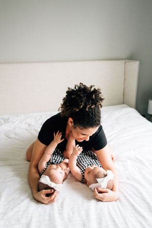 Intimate black and white progression photos showing parent and baby cuddling together on white bedding.