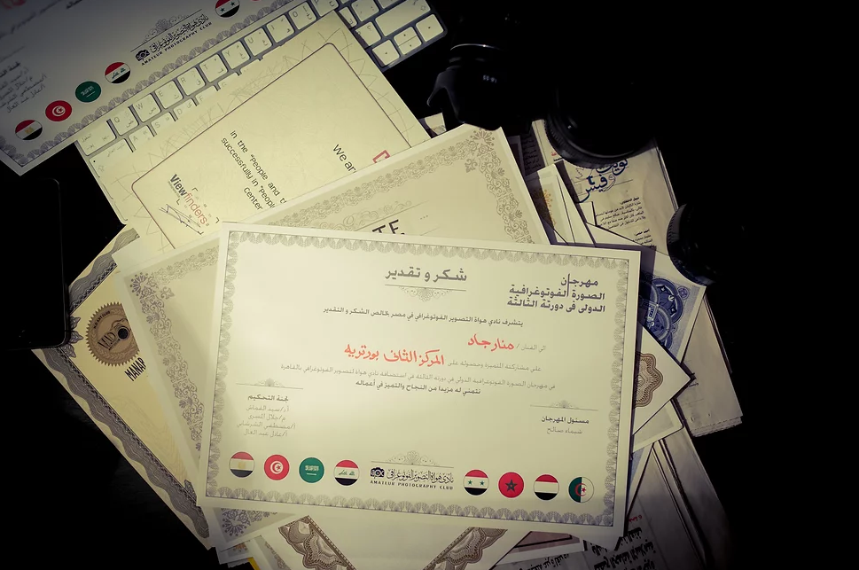 Stack of official certificates and documents with red stamps.