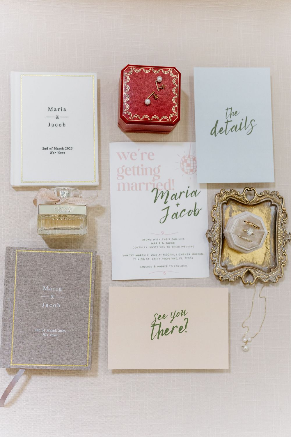 Wedding invitation suite featuring elegant gold frames, pink and gray tones, and delicate calligraphy text displayed on a neutral surface.
